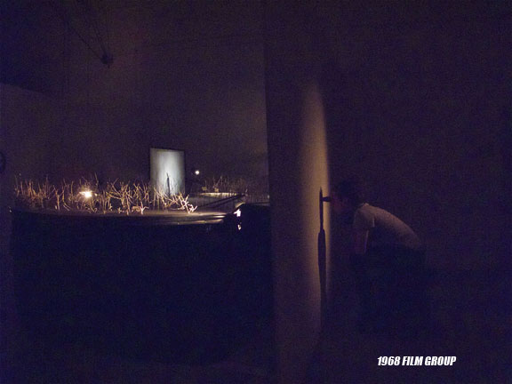 Image of a child sitting in a dark room.